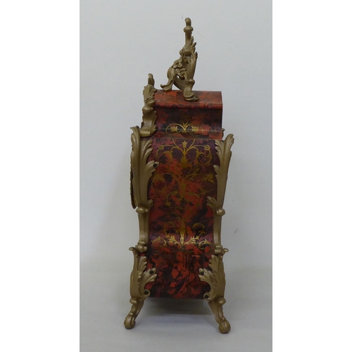 206 - A modern reproduction of an antique inspired faux boulle and tortoiseshell cased mantel clock with c... 