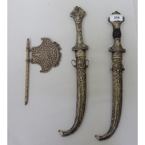 254 - Two Persian daggers, the curved blades 9