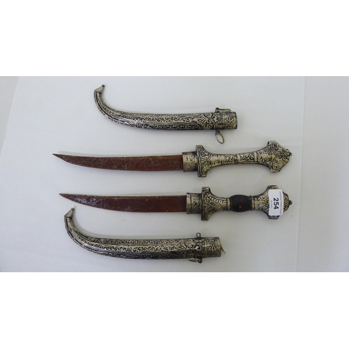 254 - Two Persian daggers, the curved blades 9