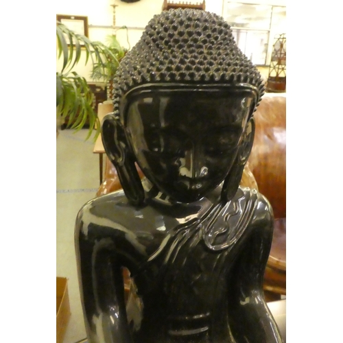 305 - A black painted ceramic model, a seated Buddha  25