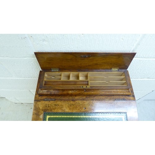 32 - WITHDRAWN A late Victorian walnut Davenport with a hinged lid and scrolled uprights, the side with f... 