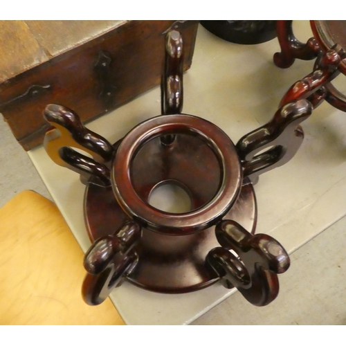 345 - Two similar modern Chinese fruitwood vase stands with scrolled feet  largest 9