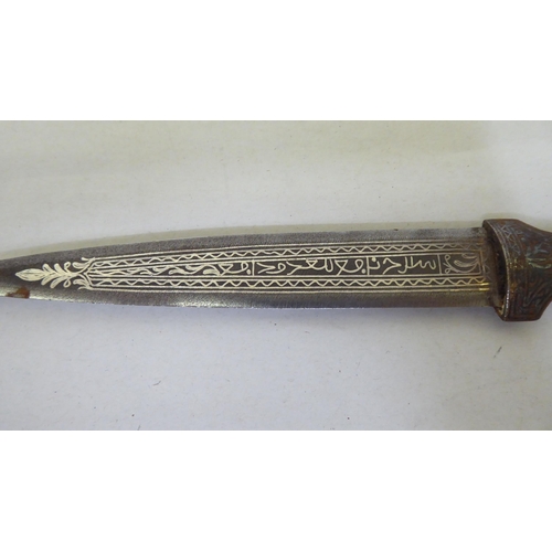 364 - A Persian dagger with a white metal handle and scabbard  the blade 7