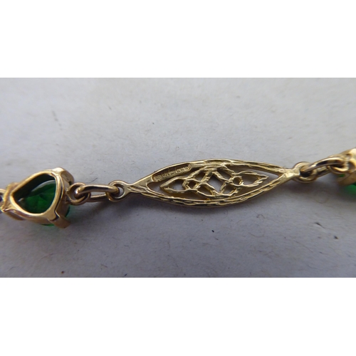 366 - A 9ct gold Irish bracelet, set with green stones