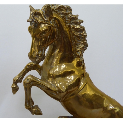 370 - A cast brass mantel clock, fashioned as a rearing horse; the 8 day movement faced by a Roman dial  2... 