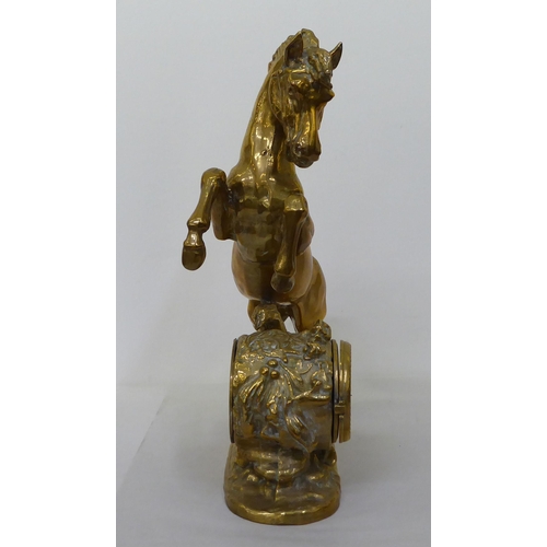 370 - A cast brass mantel clock, fashioned as a rearing horse; the 8 day movement faced by a Roman dial  2... 