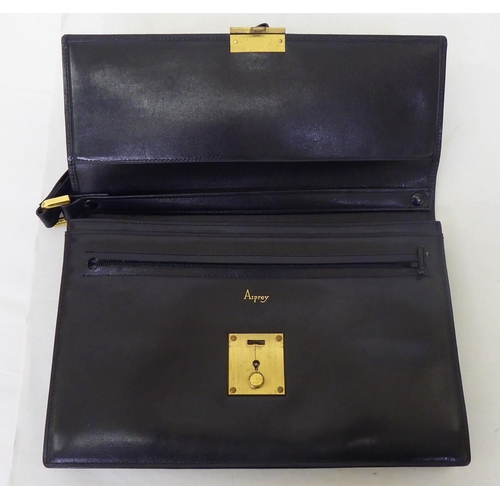 372 - An Asprey soft brown leather clutch purse with a wrist strap and lock