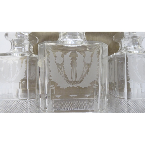 373 - A set of three lead crystal, thistle design decanters and stoppers, each with cut decoration  larges... 