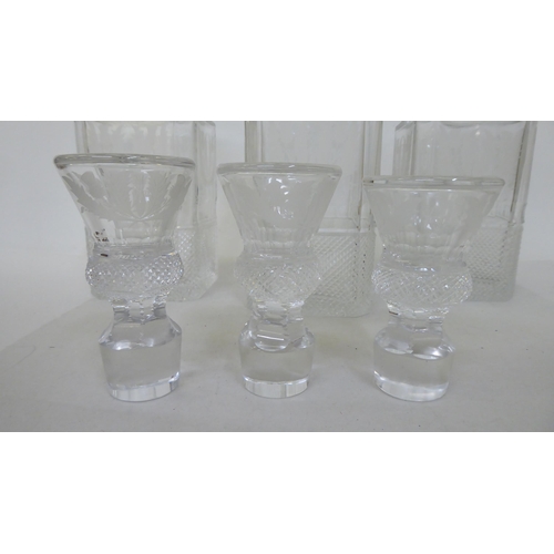 373 - A set of three lead crystal, thistle design decanters and stoppers, each with cut decoration  larges... 