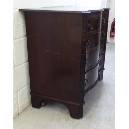 38 - An Edwardian Georgian design, serpentine front, mahogany dressing chest with four long drawers and b... 