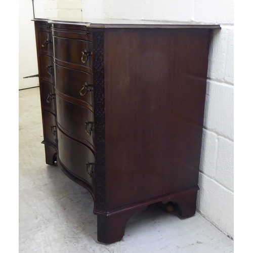 38 - An Edwardian Georgian design, serpentine front, mahogany dressing chest with four long drawers and b... 