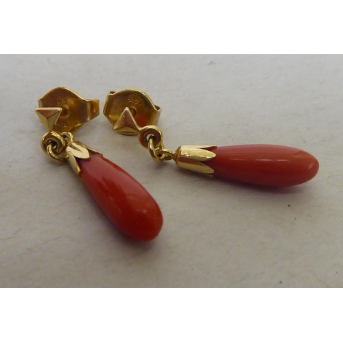 380 - A pair of 14ct gold coral pendant earrings