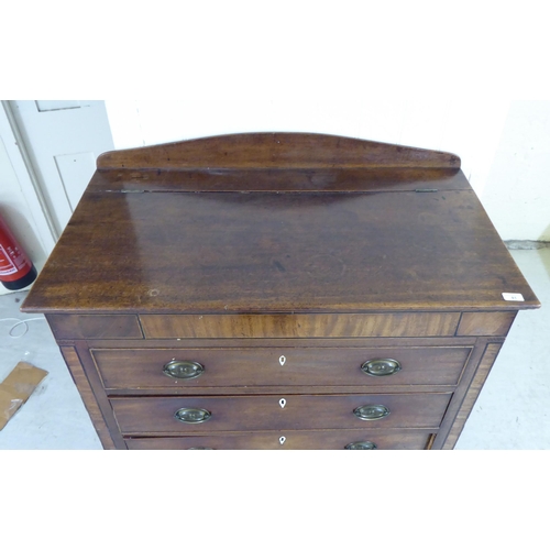 41 - An early 19thC mahogany cabinet with a hinged lid, over a facsimile drawer and three drawers, raised... 