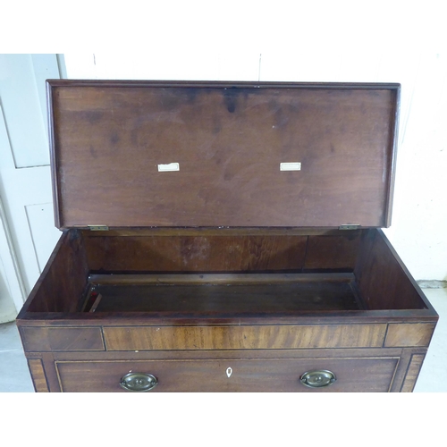 41 - An early 19thC mahogany cabinet with a hinged lid, over a facsimile drawer and three drawers, raised... 