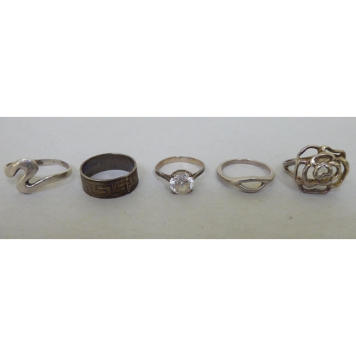 44 - Silver white metal rings  various settings and styles; and four white metal pill boxes