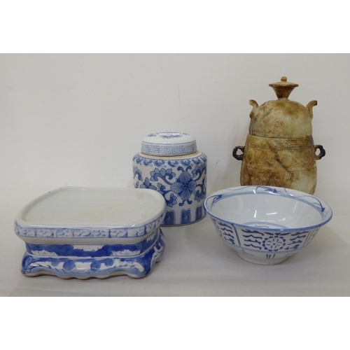 61 - Oriental collectables: to include a porcelain tea caddy, decorated with blue and white flora  7... 