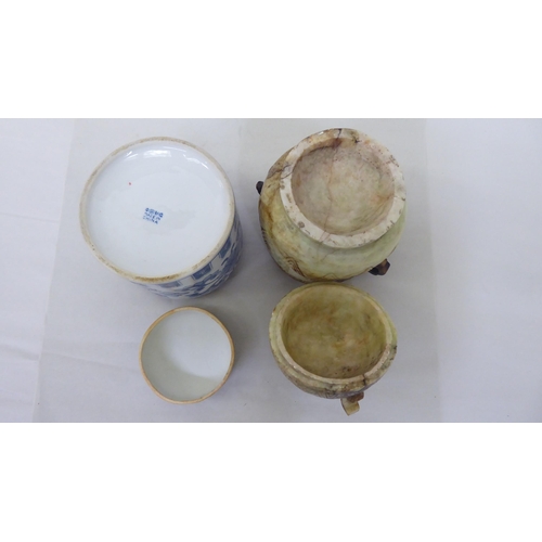 61 - Oriental collectables: to include a porcelain tea caddy, decorated with blue and white flora  7... 