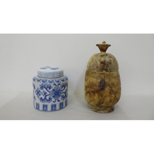 61 - Oriental collectables: to include a porcelain tea caddy, decorated with blue and white flora  7... 