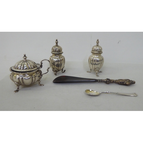 81 - Silver collectables: to include a pepper pot of demi ribbed form, on pad feet  Birmingham 1903