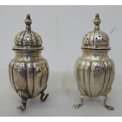 81 - Silver collectables: to include a pepper pot of demi ribbed form, on pad feet  Birmingham 1903