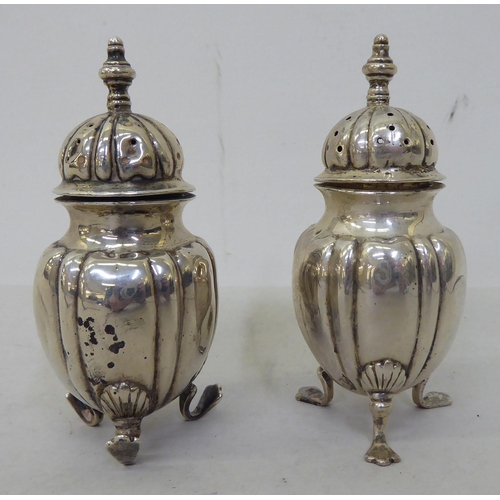 81 - Silver collectables: to include a pepper pot of demi ribbed form, on pad feet  Birmingham 1903