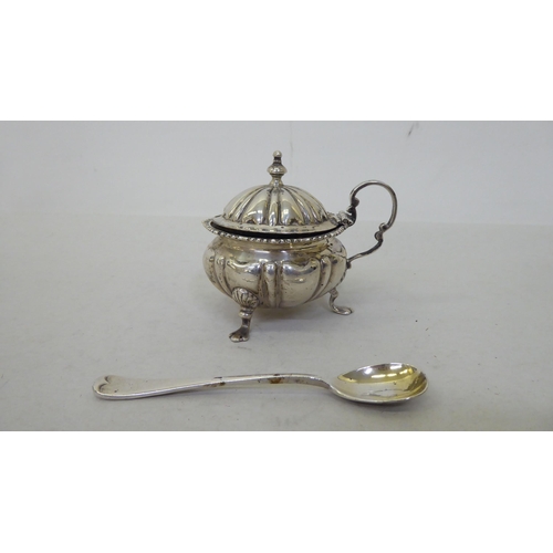 81 - Silver collectables: to include a pepper pot of demi ribbed form, on pad feet  Birmingham 1903