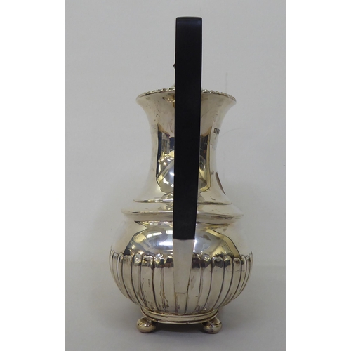 83 - An Edwardian Walker & Hall silver coffee pot of oval, demi-reeded form  Chester 1906  (approx. 2... 