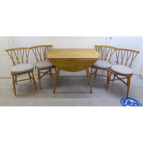 90 - An Ercol light elm drop-leaf dining table, raised on square, tapered legs  30