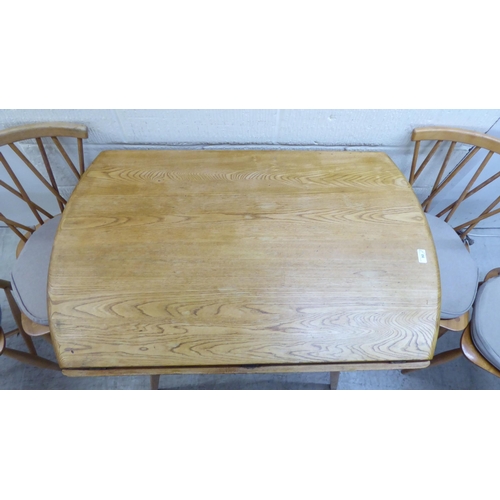 90 - An Ercol light elm drop-leaf dining table, raised on square, tapered legs  30