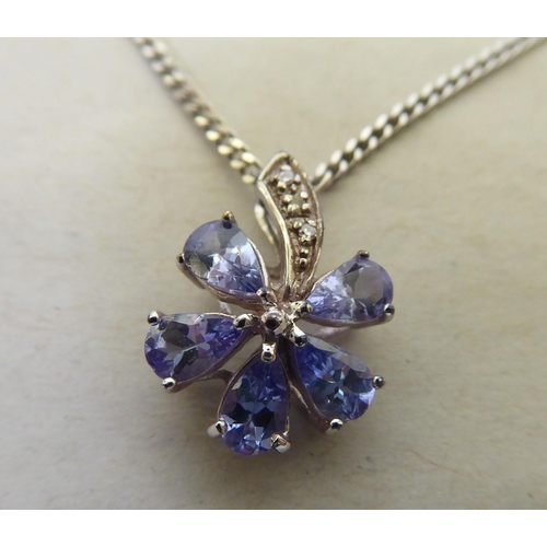 93 - A 9ct white gold pendant necklace, the petal design drop, set with coloured stones