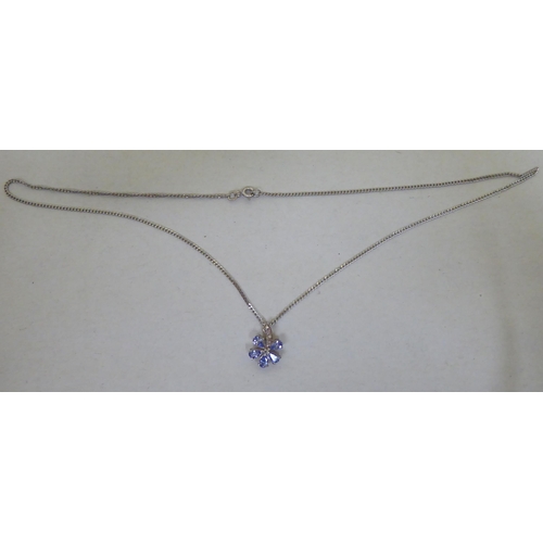 93 - A 9ct white gold pendant necklace, the petal design drop, set with coloured stones