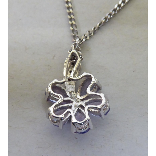 93 - A 9ct white gold pendant necklace, the petal design drop, set with coloured stones