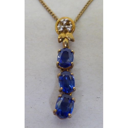 94 - A 9ct gold pendant necklace, the drop set with blue and white stones