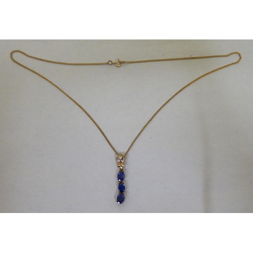 94 - A 9ct gold pendant necklace, the drop set with blue and white stones