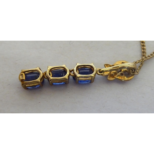 94 - A 9ct gold pendant necklace, the drop set with blue and white stones