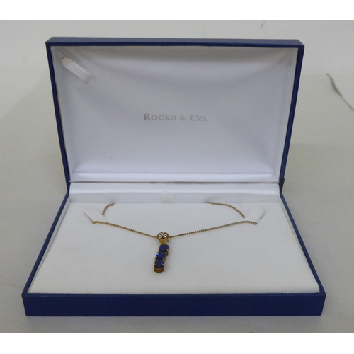 94 - A 9ct gold pendant necklace, the drop set with blue and white stones