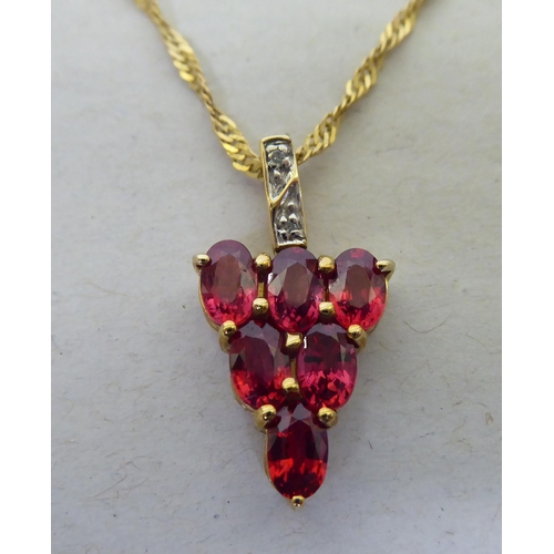 95 - A 9ct gold pendant necklace, the drop set with red and white stones