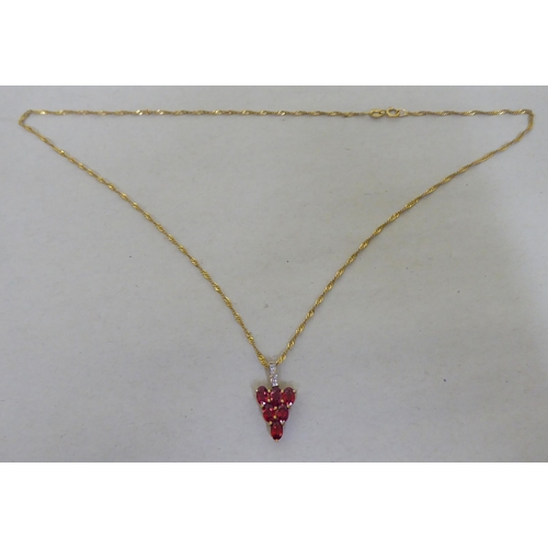 95 - A 9ct gold pendant necklace, the drop set with red and white stones