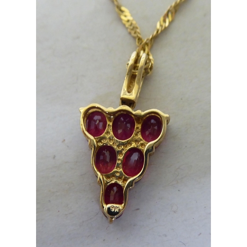 95 - A 9ct gold pendant necklace, the drop set with red and white stones