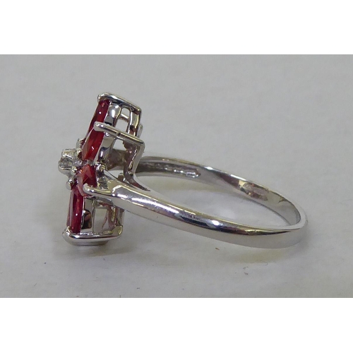 96 - A 9ct white gold, petal design ring, set with red and white stones