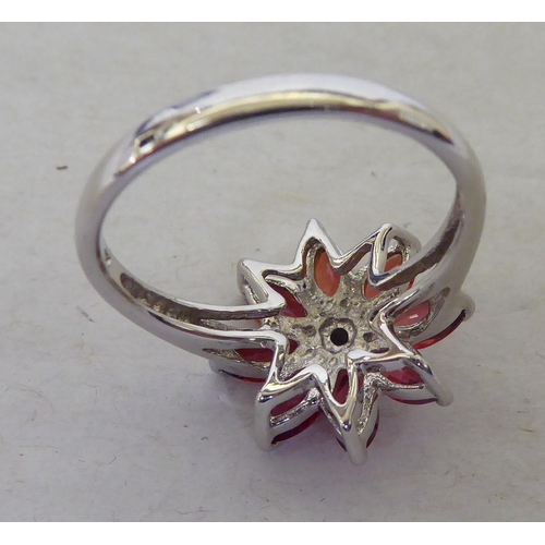 96 - A 9ct white gold, petal design ring, set with red and white stones