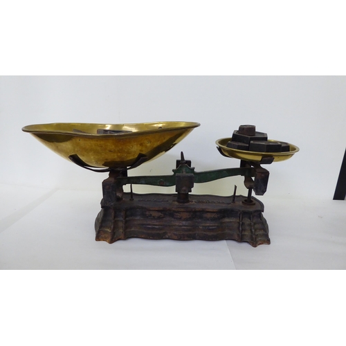 224 - 20thC metalware: to include a set of early 20thC cast iron scales with brass weighing trays and atte... 