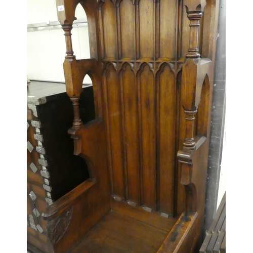 304 - A late Victorian honey coloured oak, Bishop's throne with a high, canopied back with Gothic tracery ... 