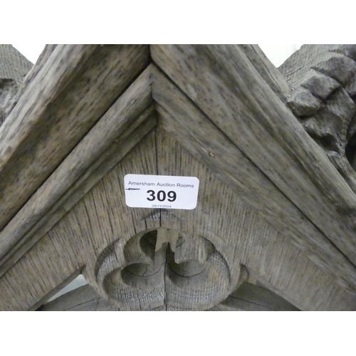 309 - A 19thC bleached oak, carved and part glazed niche, in Gothic taste with an arched top, an open fron... 