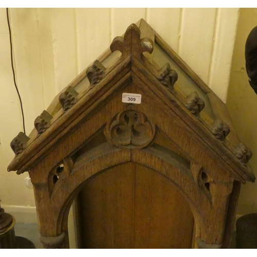 309 - A 19thC bleached oak, carved and part glazed niche, in Gothic taste with an arched top, an open fron... 