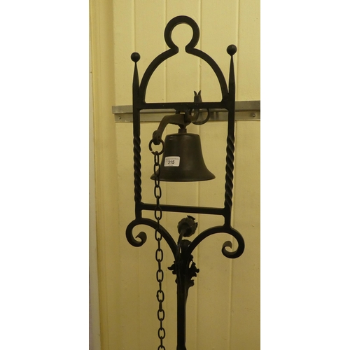 315 - A late 19thC blackened steel, freestanding bell, in an ornately cast frame, on a barleytwist stem an... 