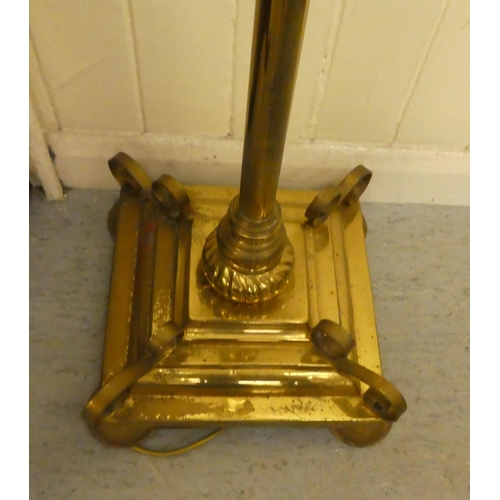 319 - A late Victorian brass finished lamp standard, the reservoir supported by a tubular column, converte... 