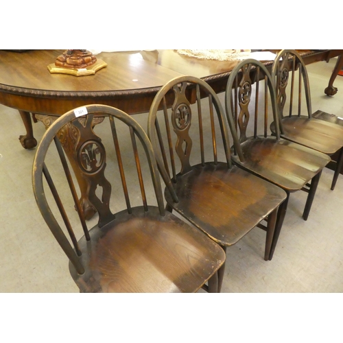 321 - A set of four dark stained Ercol hoop and spindled back chairs, the solid seats raised on turned leg... 