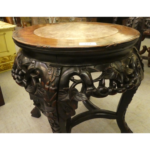 324 - A late 19thC profusely carved teak jardinière stand with an inset marble top, raised on cabri... 