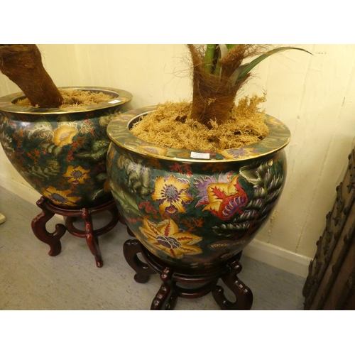 325 - A pair of Japanese style china fish bowls, decorated in bold colours with flora and gilding  14... 